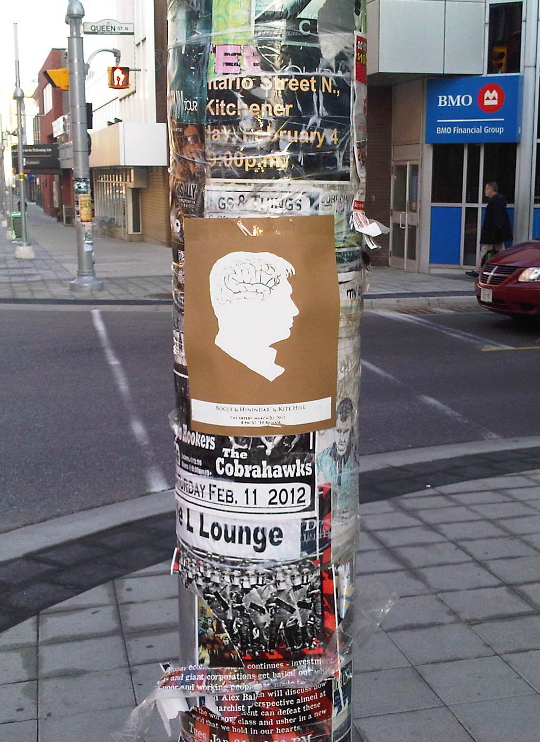 art show poster on street post filled with posters